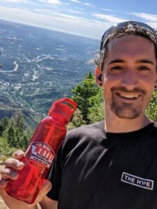 A happy customer with Red Wing Motel water bottle atop the Manitou incline
