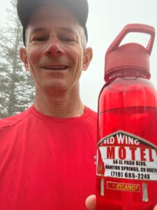 A happy man with Red Wing Motel water bottle atop the Manitou incline