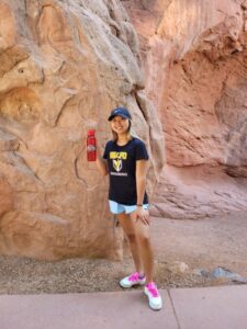 Woman hiker showing Red Wing Motel water bottle